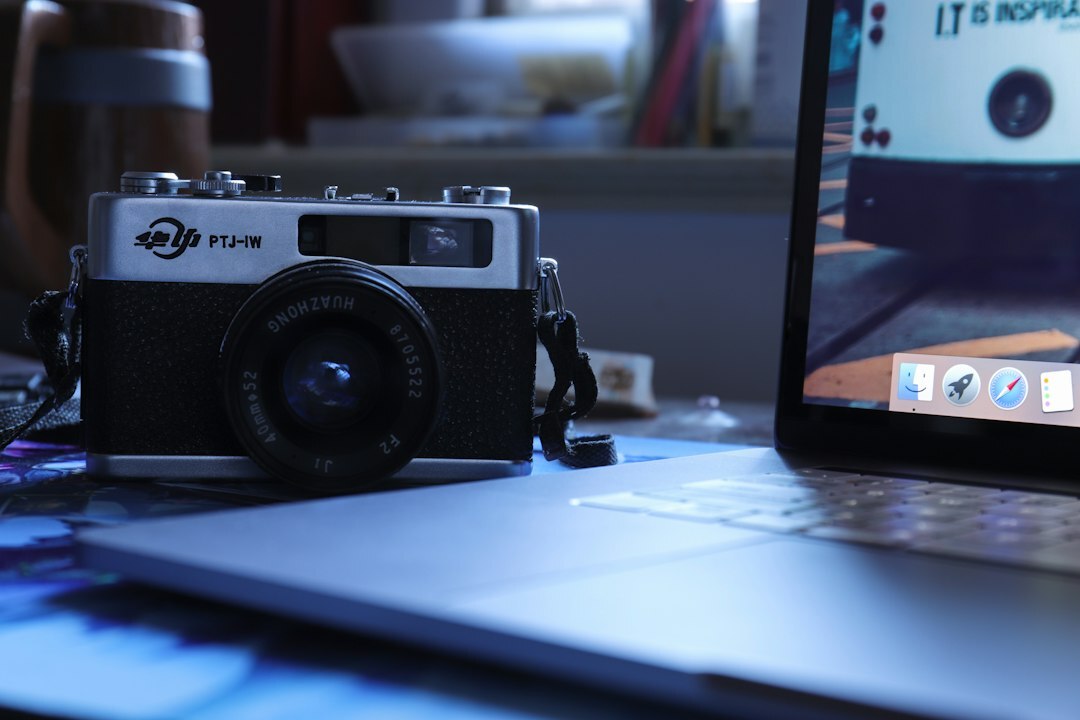 Photo editor reviewing documentary photographs on a laptop