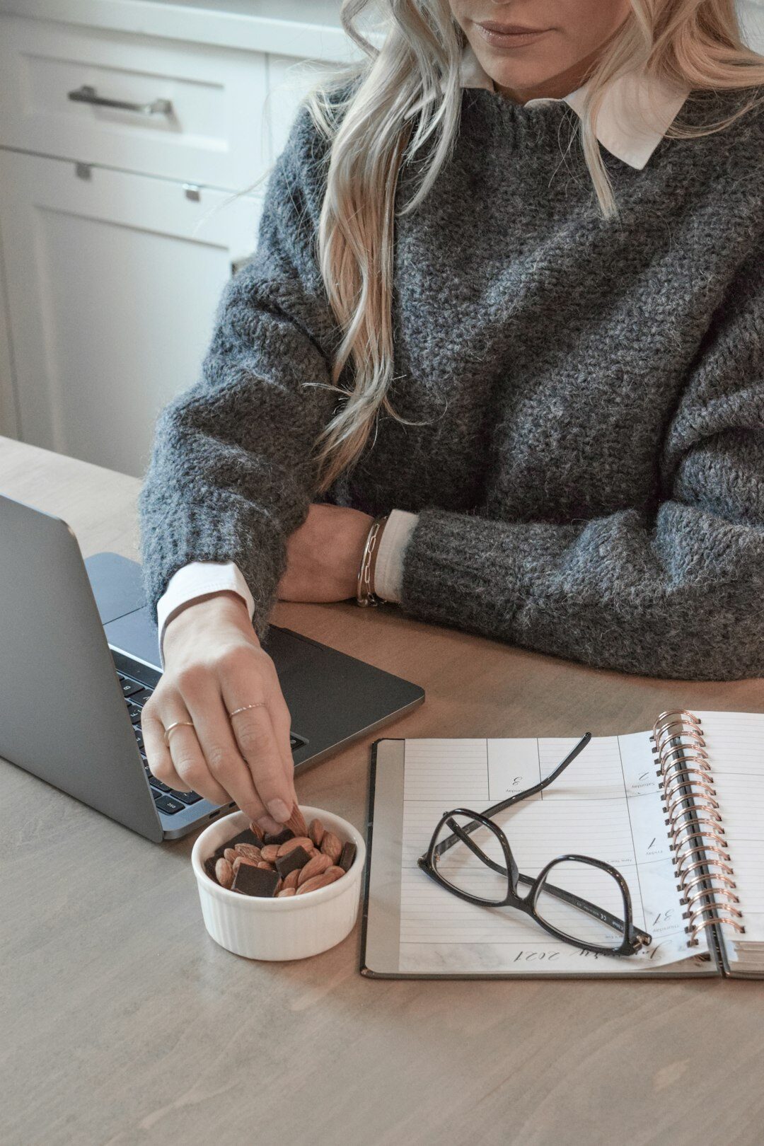person calculating budget on laptop