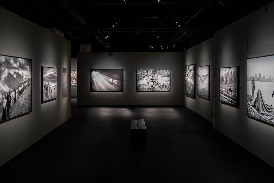 Black and white photographs displayed on a gallery wall